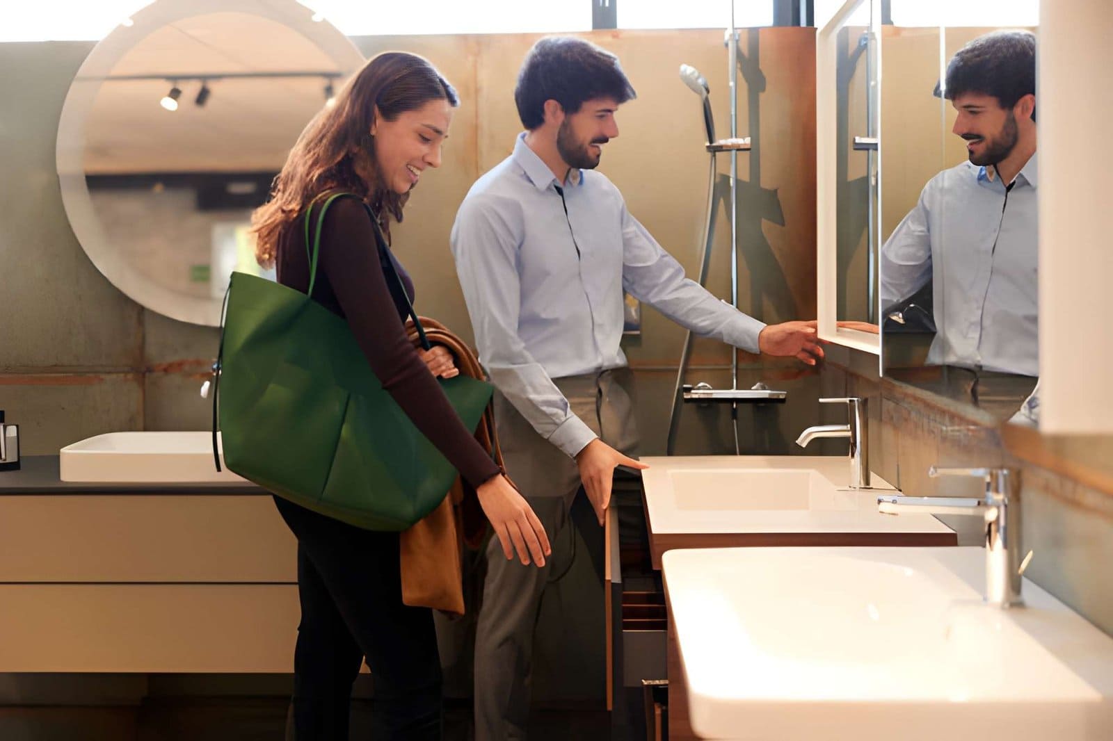 Bathroom remodel companies near me—customer viewing vanity and mirrored cabinet in modern showroom.