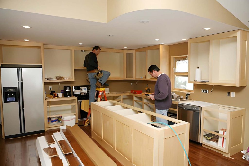 Kitchen remodel Stuart FL—contractors installing cabinets and fixtures during active renovation project.v