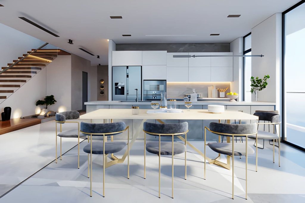 Luxury kitchen remodel contractor near me—modern white kitchen with island, dining table, and gold-frame chairs.