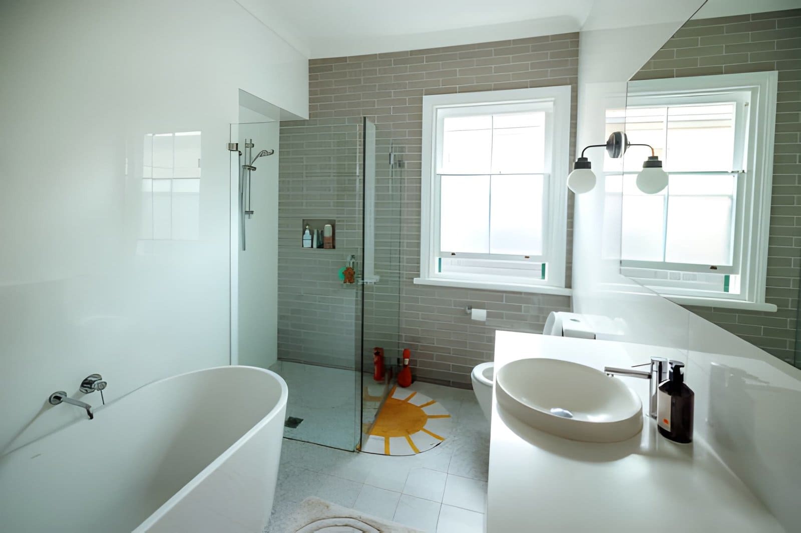 Modern bathroom remodel in Palm Beach Gardens featuring freestanding tub, glass shower, and vessel sink
