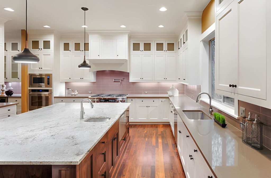 Kitchen remodeling Palm City FL featuring modern island with stone countertop and pendant lighting